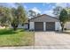 Charming single-story home with a two-car garage and well-maintained lawn at 10339 Manila Bay Dr, Orlando, FL 32821
