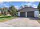 View of the two-car garage with gray doors and neutral-colored exterior at 10339 Manila Bay Dr, Orlando, FL 32821