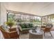 Relaxing screened lanai with comfortable seating and serene views of the landscaped backyard at 10339 Manila Bay Dr, Orlando, FL 32821