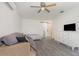 Open living area features wood floors, a ceiling fan, white walls, and access to other rooms through a sliding door at 10339 Manila Bay Dr, Orlando, FL 32821
