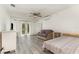 Living room with wood floors, ceiling fan, white walls, and a glass door that provides plenty of natural light at 10339 Manila Bay Dr, Orlando, FL 32821