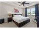 Main bedroom with a tray ceiling, ceiling fan, and large window for natural light at 1112 Narcoossee Del Sol Blvd, St Cloud, FL 34771