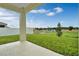 Lush backyard with covered patio overlooking green space at 1132 Clay Blvd, Tavares, FL 32778