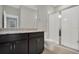 Modern bathroom with a glass enclosed shower, granite countertop, and dark wood cabinets at 1132 Clay Blvd, Tavares, FL 32778