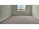 Bedroom featuring neutral carpeting, base trim, and a window for natural light at 1132 Clay Blvd, Tavares, FL 32778
