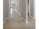 Bright hallway with beige tile flooring and a view of the outdoors at the end at 1132 Clay Blvd, Tavares, FL 32778