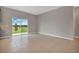 Bright living room features tile flooring, natural light from the sliding glass doors to the backyard at 1132 Clay Blvd, Tavares, FL 32778