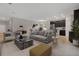 Open-concept living room with tile floors, modern furnishings, and a view into the kitchen at 1132 Clay Blvd, Tavares, FL 32778