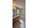 Bright bathroom with a single sink vanity, a large mirror, and a separate tub, creating a spa-like experience at 12151 Goldenstar Ln, Clermont, FL 34711