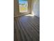 Bright bedroom featuring a window and door at 12151 Goldenstar Ln, Clermont, FL 34711