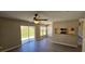 Cozy dining area features modern flooring, a ceiling fan, and an open floor plan with a view to the backyard at 12151 Goldenstar Ln, Clermont, FL 34711