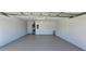 Clean, spacious garage with white walls and a gray floor, ready for storage at 12151 Goldenstar Ln, Clermont, FL 34711