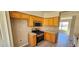 Well-lit kitchen featuring wood cabinets, laminate countertops, and stainless steel appliances, providing a modern culinary space at 12151 Goldenstar Ln, Clermont, FL 34711