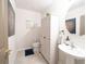 Powder room featuring a pedestal sink, modern fixtures, and decorative artwork at 1217 Michelangelo Ln, Winter Haven, FL 33884