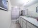 Bathroom featuring a shower-tub combo, granite counters, and modern fixtures at 1217 Michelangelo Ln, Winter Haven, FL 33884