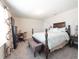 This bedroom showcases a wood bed frame, work desk, and large window with gray carpet at 1217 Michelangelo Ln, Winter Haven, FL 33884