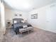 Cozy bedroom featuring a gray upholstered bed frame, bench, and neutral decor at 1217 Michelangelo Ln, Winter Haven, FL 33884