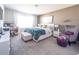 Comfortable bedroom with a large window, plush carpeting, and a cozy reading nook at 1217 Michelangelo Ln, Winter Haven, FL 33884