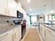 Kitchen with white cabinets, granite countertops, and stainless steel appliances at 1217 Michelangelo Ln, Winter Haven, FL 33884