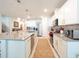 Bright kitchen with white cabinets, granite counters, stainless appliances, and island seating at 1217 Michelangelo Ln, Winter Haven, FL 33884