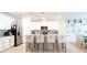 Spacious kitchen featuring white cabinets, granite counters, stainless appliances, and island seating at 1217 Michelangelo Ln, Winter Haven, FL 33884