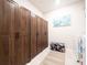 Laundry room featuring ample storage in floor-to-ceiling wood cabinets at 1217 Michelangelo Ln, Winter Haven, FL 33884