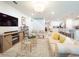 Open-concept living room featuring neutral tones, stylish decor, and hardwood-style flooring at 1217 Michelangelo Ln, Winter Haven, FL 33884