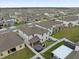 A high-angle aerial view of a neighborhood showcasing a large, well-maintained lawn at 1240 Lone Palm Way, St Cloud, FL 34771