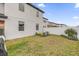 The backyard features a white fence, green grass, and newly planted landscaping at 1240 Lone Palm Way, St Cloud, FL 34771