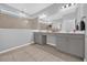 Bathroom featuring double sinks, a large mirror, neutral tiling, and modern lighting at 1240 Lone Palm Way, St Cloud, FL 34771