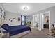 Comfortable bedroom with carpet, large windows, wall decor, and a bed with blue duvet at 1240 Lone Palm Way, St Cloud, FL 34771