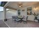 Relaxing covered patio with a dining table, ceiling fan, and cozy seating for outdoor enjoyment at 1240 Lone Palm Way, St Cloud, FL 34771