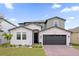 Charming two-story home featuring a brick driveway and landscaped front yard at 1240 Lone Palm Way, St Cloud, FL 34771