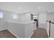 Upstairs hallway with carpet flooring, and railing overlooking the living area at 1240 Lone Palm Way, St Cloud, FL 34771