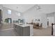 Open concept kitchen with gray cabinets, large island, and modern lighting, adjacent to dining and living area at 1240 Lone Palm Way, St Cloud, FL 34771