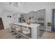 Modern kitchen island with seating, stainless steel appliances, and custom cabinets at 1240 Lone Palm Way, St Cloud, FL 34771