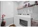 Well-equipped laundry room with modern appliances and shelving for storage at 1240 Lone Palm Way, St Cloud, FL 34771