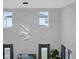 View of living area, showcasing modern lighting and large windows overlooking exterior at 1240 Lone Palm Way, St Cloud, FL 34771