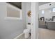 Contemporary powder room with a toilet and small decorative items for a modern touch at 1240 Lone Palm Way, St Cloud, FL 34771
