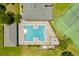 Aerial view of pool featuring lounge chairs, spa, and tennis courts at 1270 Falling Star Ln, Orlando, FL 32828