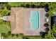 Aerial view of pool featuring lounge chairs and trees around property at 1270 Falling Star Ln, Orlando, FL 32828