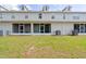 Backyard featuring a grassy lawn and screened-in back patio at 1270 Falling Star Ln, Orlando, FL 32828