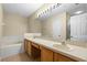 Bright bathroom with double sink vanity, large mirror, soaking tub and neutral color palette at 1270 Falling Star Ln, Orlando, FL 32828