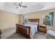 Spacious bedroom featuring a tray ceiling, ceiling fan, and two windows that provide natural light at 1270 Falling Star Ln, Orlando, FL 32828
