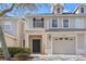 Charming two-story townhouse featuring a private front balcony, attached garage, and manicured landscaping at 1270 Falling Star Ln, Orlando, FL 32828