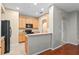 Well-lit kitchen featuring wooden cabinets, tile flooring and black appliances at 1270 Falling Star Ln, Orlando, FL 32828