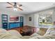 Cozy living room with a ceiling fan, sliding glass doors to a screened patio and hardwood floors at 1270 Falling Star Ln, Orlando, FL 32828