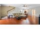 Open concept living room with hardwood floors and staircase adjacent to the dining area and kitchen at 1270 Falling Star Ln, Orlando, FL 32828