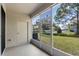 Enclosed screened patio providing views of the green lawn, trees and street at 1270 Falling Star Ln, Orlando, FL 32828