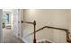 Carpeted staircase featuring a wooden handrail and access to the upper level of the home at 1270 Falling Star Ln, Orlando, FL 32828